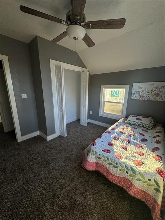 bedroom featuring dark colored carpet, vaulted ceiling, and ceiling fan