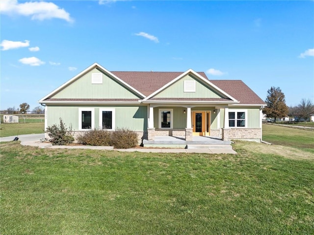 view of front of property with covered porch and a front lawn