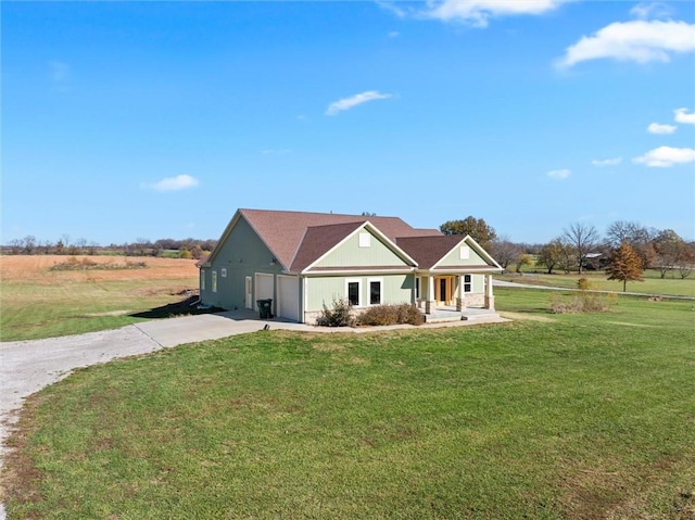 ranch-style house with a rural view, covered porch, and a front yard