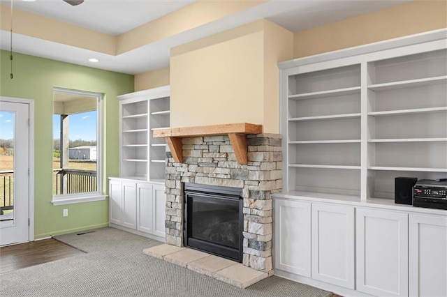 unfurnished living room featuring a fireplace and light colored carpet