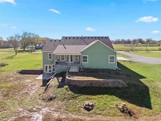 rear view of property with a lawn