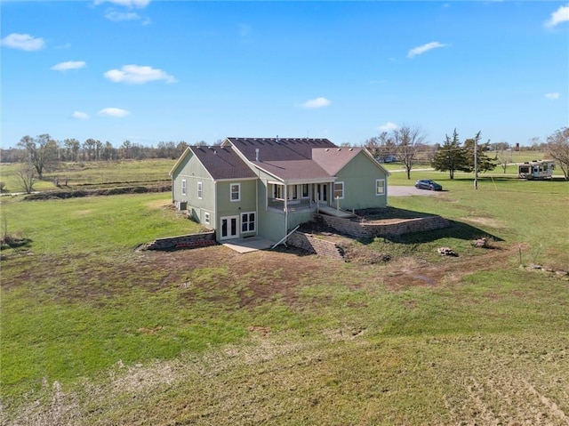 exterior space featuring a lawn and a rural view