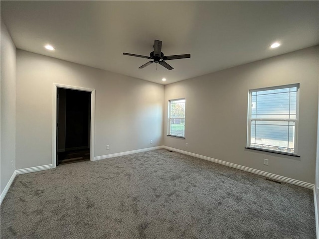 carpeted empty room featuring ceiling fan