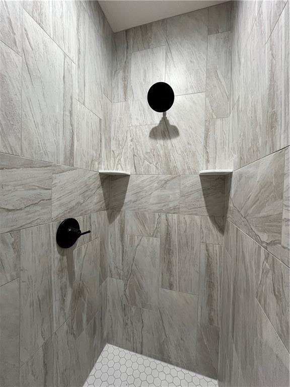 bathroom with tiled shower