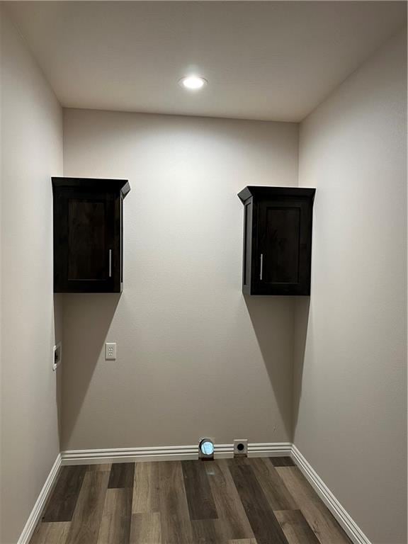 clothes washing area featuring dark hardwood / wood-style flooring, cabinets, and hookup for an electric dryer