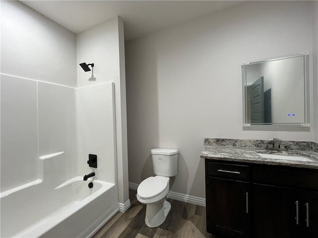 full bathroom featuring toilet, tub / shower combination, vanity, and hardwood / wood-style floors