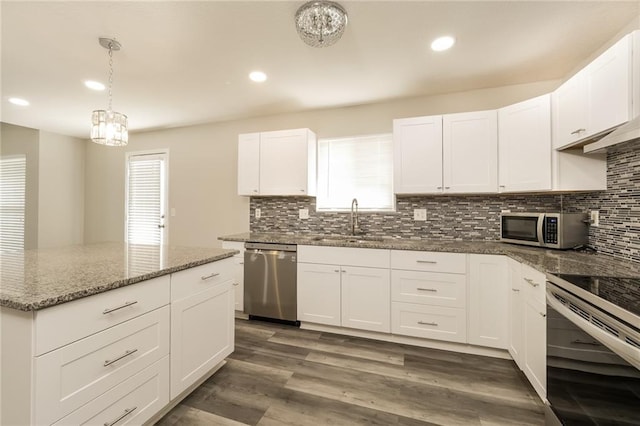 kitchen featuring stainless steel appliances, white cabinetry, sink, and dark wood-type flooring