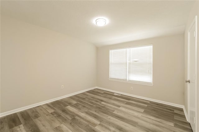 unfurnished room featuring hardwood / wood-style floors