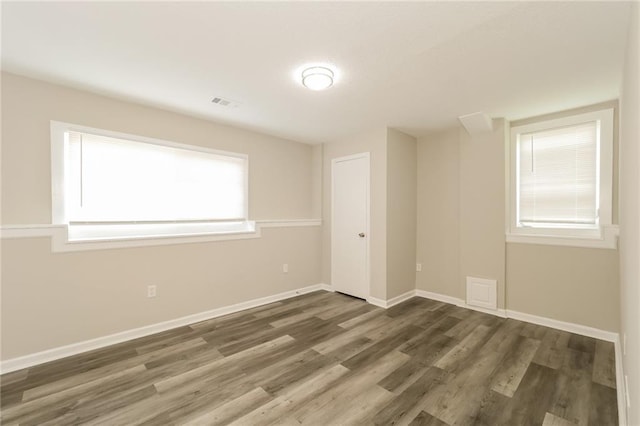 spare room with dark wood-type flooring