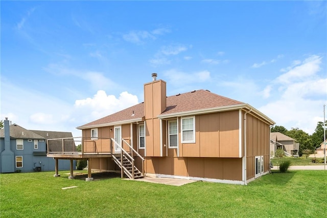 back of house with a lawn and a wooden deck