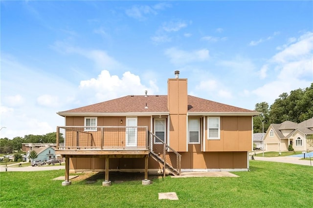 back of property featuring a lawn and a garage