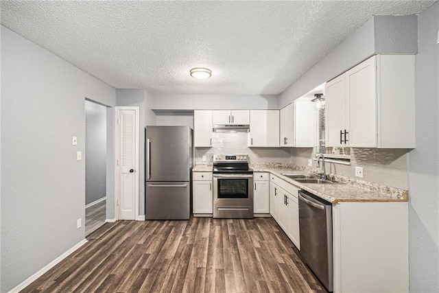 kitchen with stainless steel appliances, dark wood-type flooring, sink, a textured ceiling, and white cabinetry