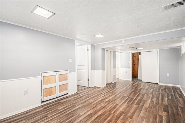 unfurnished room featuring hardwood / wood-style floors and a textured ceiling