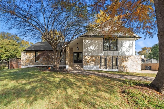 rear view of house featuring a lawn