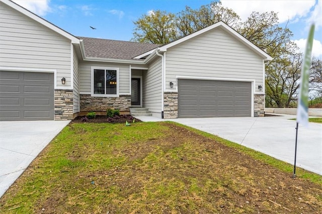 view of front facade featuring stone siding, a shingled roof, driveway, and a garage