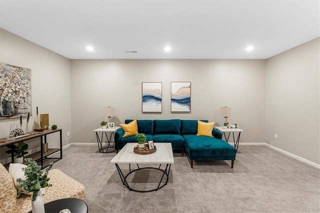 carpeted living area featuring baseboards, visible vents, and recessed lighting