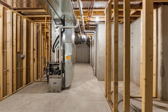 unfinished basement featuring heating unit