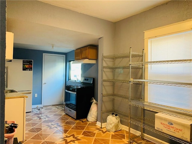 kitchen featuring gas stove and white refrigerator