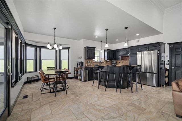 dining space featuring a chandelier, recessed lighting, visible vents, baseboards, and ornamental molding