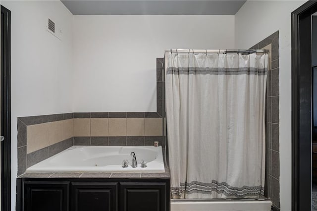 bathroom featuring visible vents, a garden tub, and a shower stall