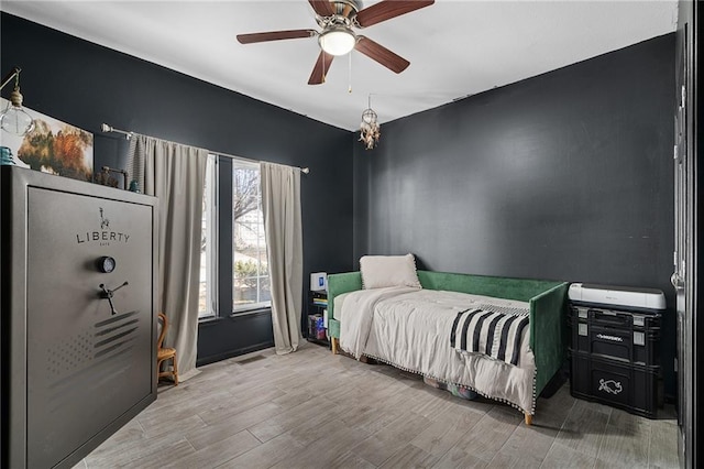 bedroom with a ceiling fan and wood finished floors