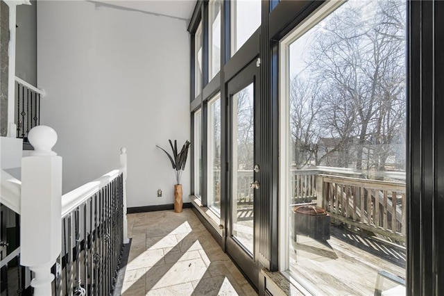 interior space with a towering ceiling and baseboards