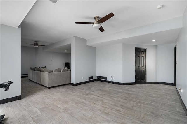 unfurnished living room with light wood-style floors, visible vents, baseboards, and a ceiling fan