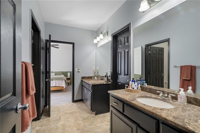 full bathroom with ensuite bathroom, two vanities, and a sink