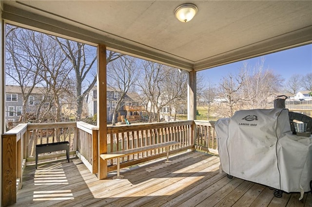 wooden terrace featuring a grill