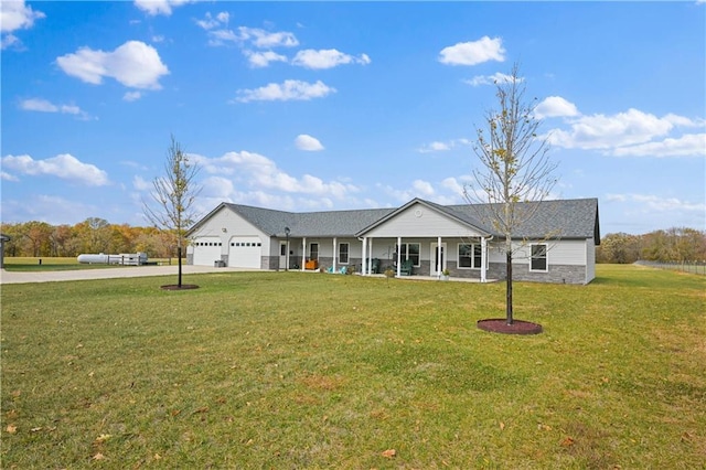 ranch-style home with a garage, a front yard, and a porch