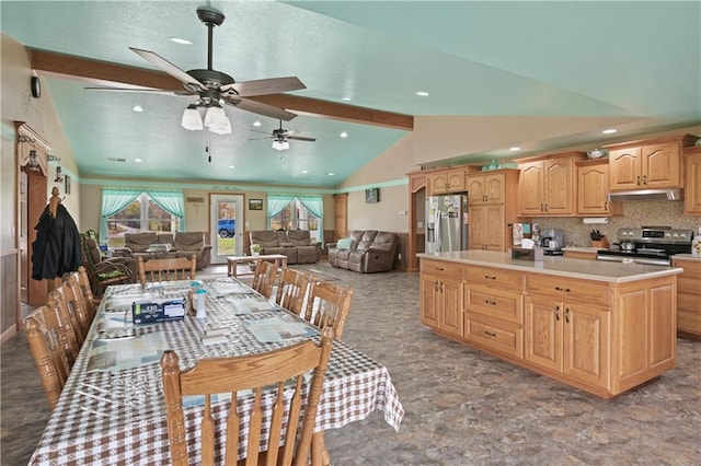 kitchen with tasteful backsplash, ceiling fan, a kitchen island, lofted ceiling with beams, and appliances with stainless steel finishes