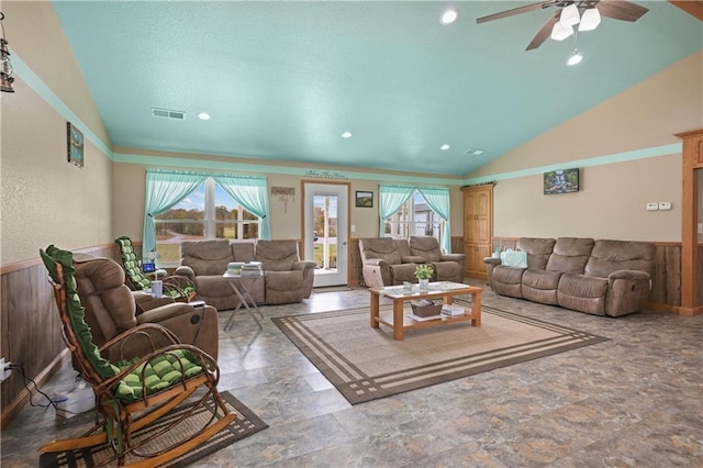 living room featuring plenty of natural light, ceiling fan, and vaulted ceiling