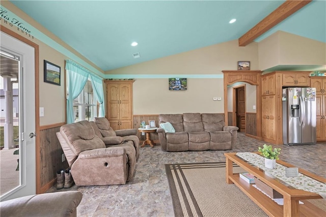 living room featuring vaulted ceiling with beams and plenty of natural light