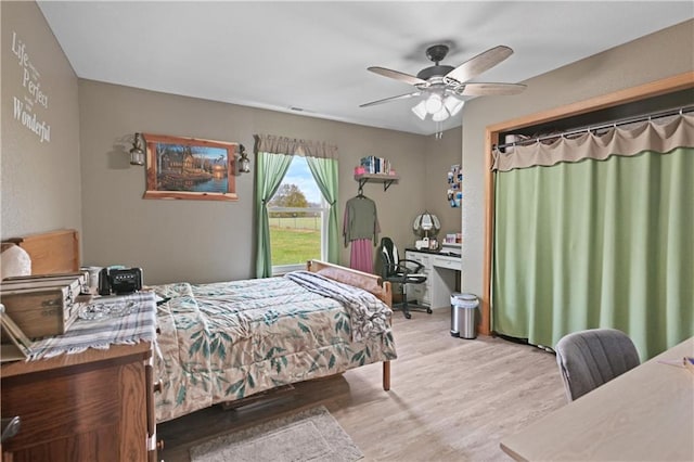 bedroom featuring light hardwood / wood-style floors and ceiling fan