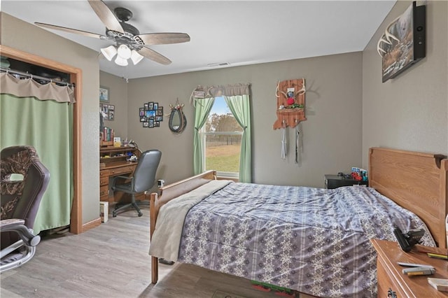 bedroom featuring light hardwood / wood-style floors and ceiling fan