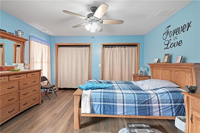 bedroom with hardwood / wood-style flooring and ceiling fan