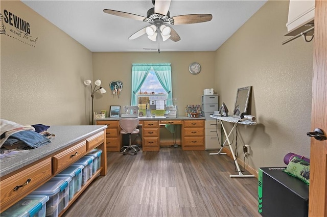 office space featuring ceiling fan and dark hardwood / wood-style floors