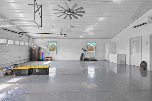 garage featuring a wall unit AC and white fridge