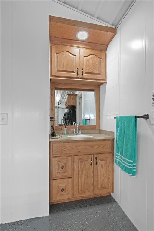 bathroom with vanity and lofted ceiling