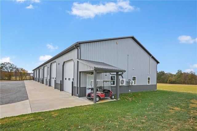 view of outdoor structure with a garage and a lawn