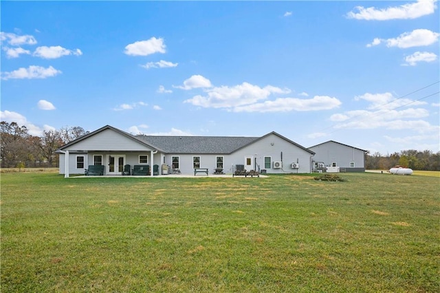 back of house with a yard and a patio area