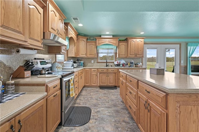 1185 Route E, Lockwood, MO 65682 - kitchen with a sink, light countertops, stainless steel appliances, under cabinet range hood, and visible vents