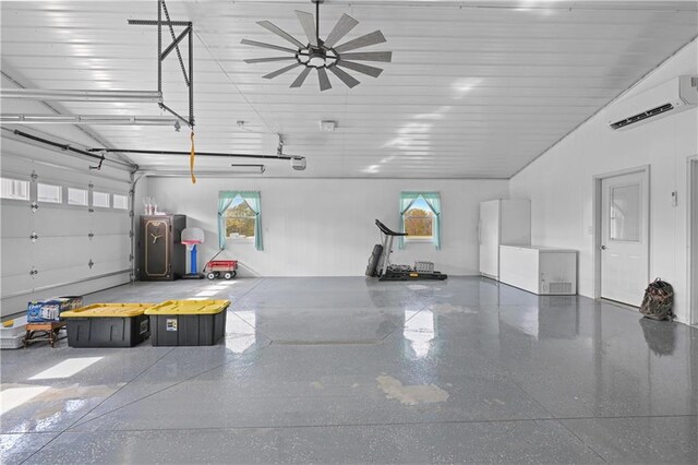 1185 Route E, Lockwood, MO 65682 - garage with freestanding refrigerator, ceiling fan, a wall unit AC, and a garage door opener