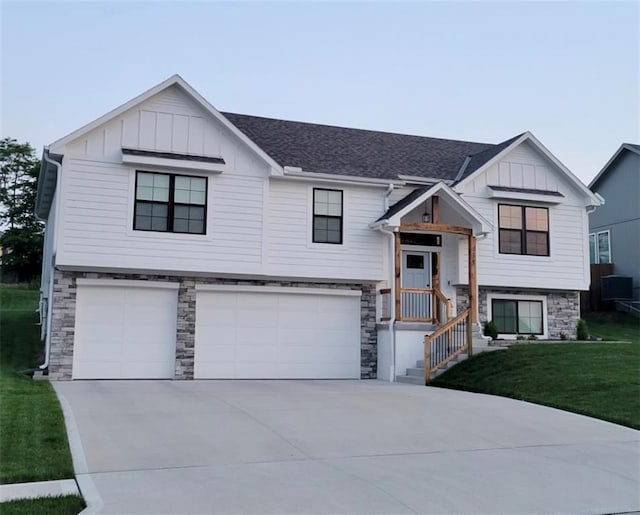 split foyer home with a garage and a front lawn