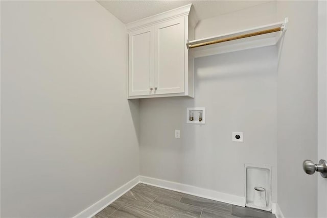 laundry room featuring washer hookup, electric dryer hookup, and cabinets