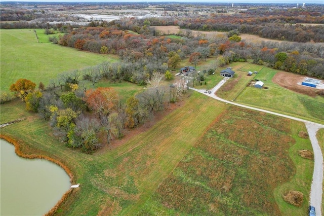 birds eye view of property featuring a water view and a rural view