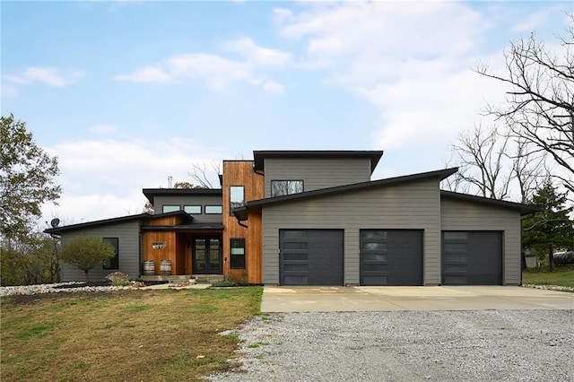 contemporary home with a garage and a front yard