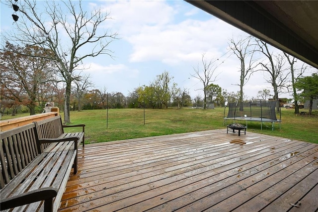 deck featuring a yard and a trampoline