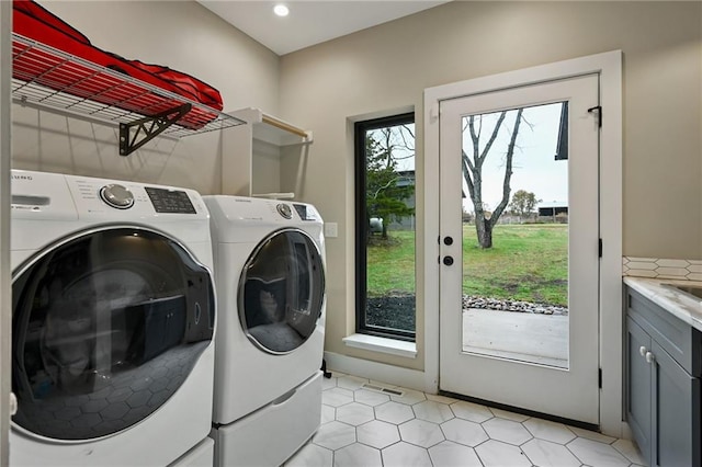 washroom featuring cabinets and independent washer and dryer