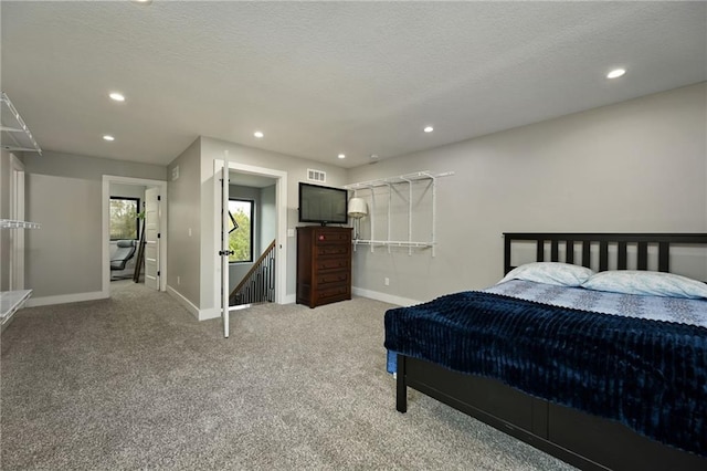 bedroom featuring carpet and a textured ceiling